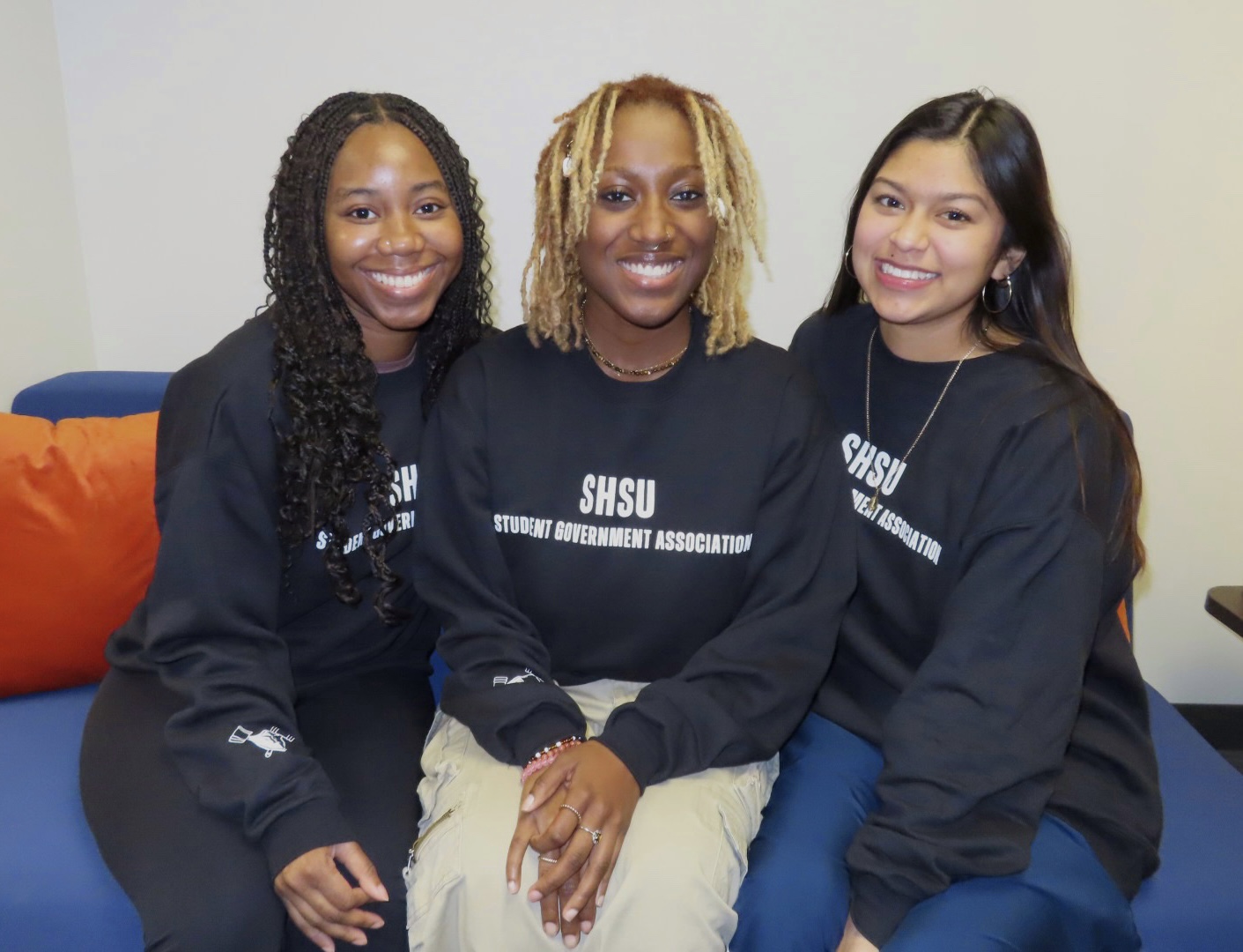 SGA Group members showing off SGA Crewneck sweatshirts